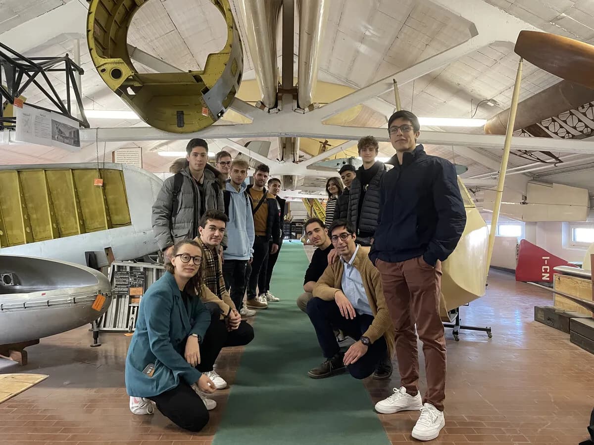 High school students from Space Eagle with team members in the workshop.