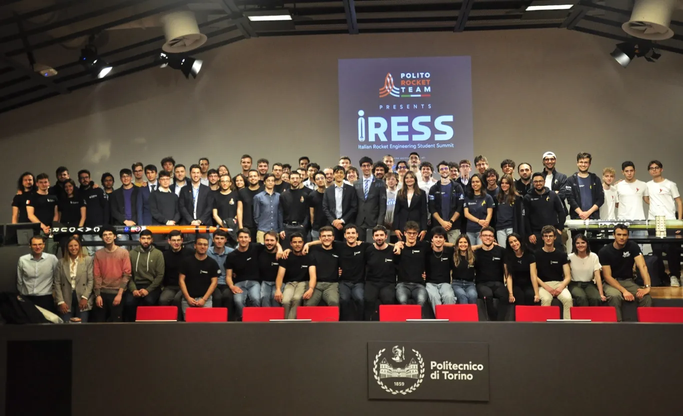 Students from Italy's rocket teams in the Aula Magna of Politecnico di Torino, under the IRESS screen.