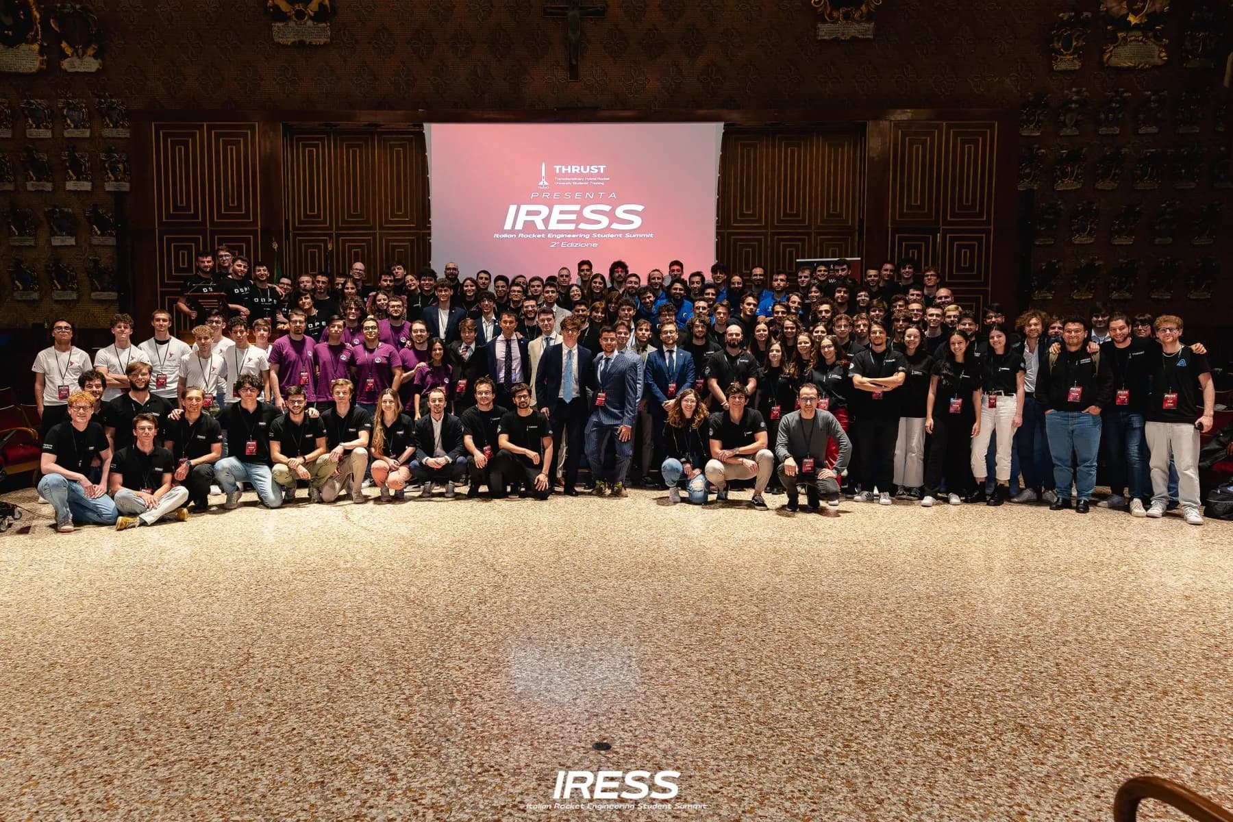 Students from Italy's rocket teams under the IRESS screen at the second edition in Padova.